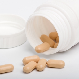 capsules spilling out of a bottle